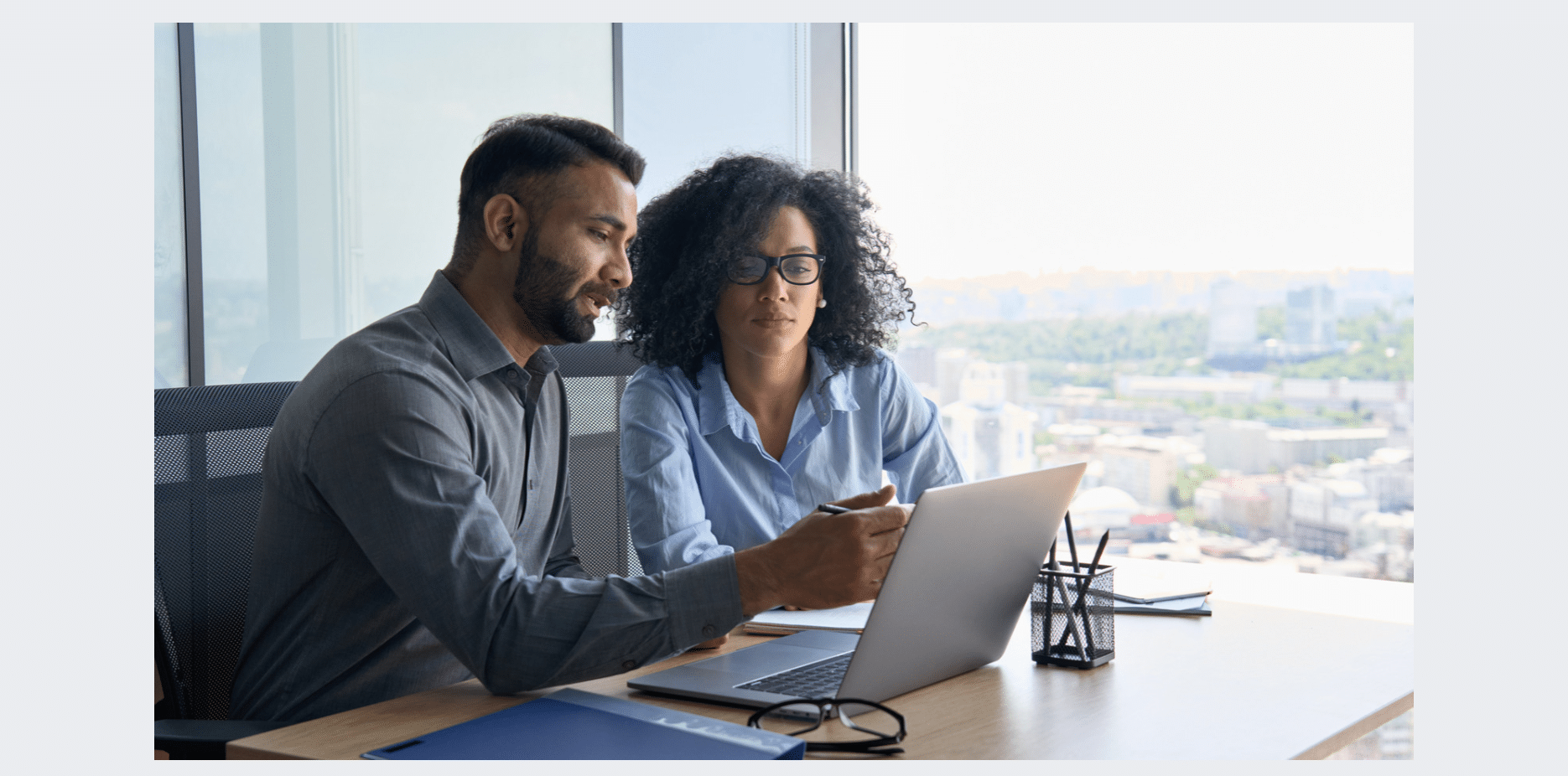 Two people looking at a laptop screen together